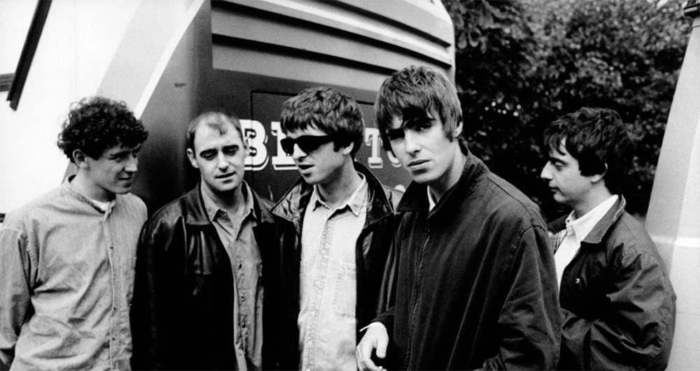 7-Oasis-Tony-McCarroll-Paul-Arthurs-Noel-Gallagher-Liam-Gallagher-et-Paul-McGuigan-par-Michel-Linssen-1994